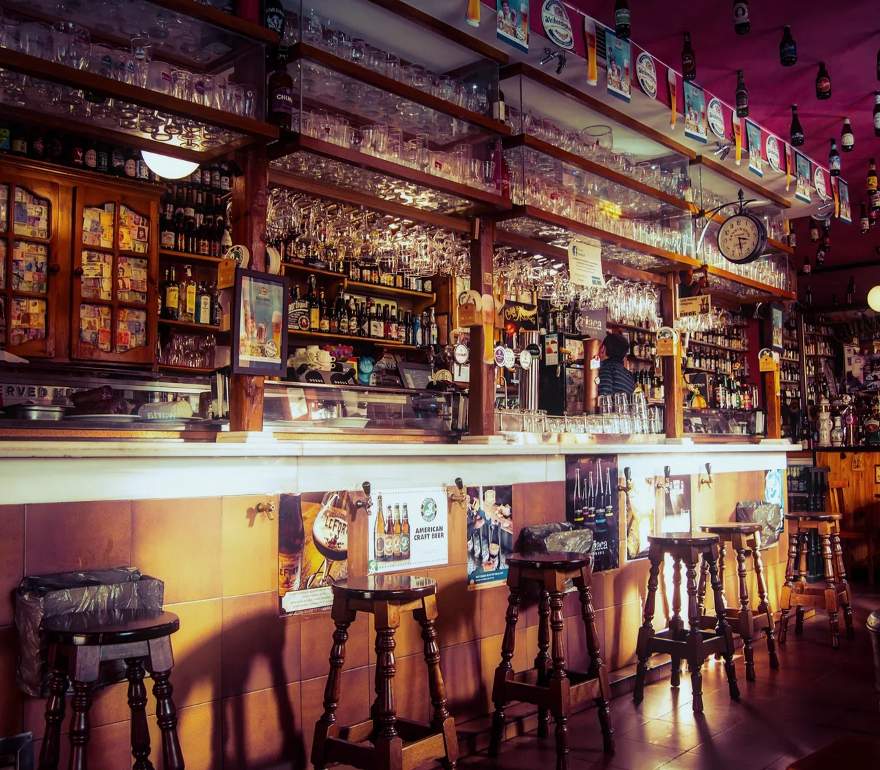 Busy traditional pub bar with a full back-bar of taps